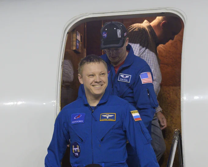Roscosmos cosmonaut Aleksandr Gorbunov smiles as he returns to Johnson Space Center's Ellington Field in Houston, Texas. Credit: NASA/Robert Markowitz