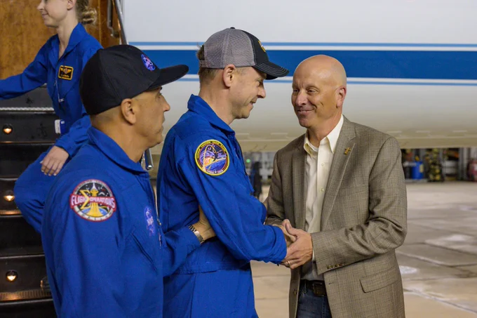 NASA astronaut Nick Hague returns to Johnson Space Center's Ellington Field in Houston, Texas with Chief of the Astronaut Office, Joe Acaba, and is greeted by Steve Koerner, acting center director. Credit: NASA/Robert Markowitz