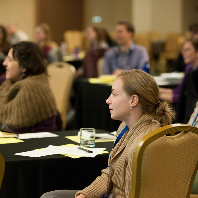 People listening to a presenter.