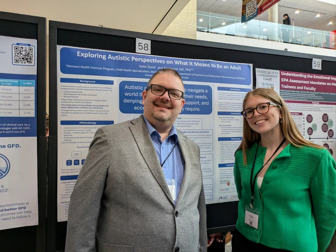 Dr. Mackenzie Salt and Katie Stock smile and stand with their poster at McMaster Child Health Research Day.