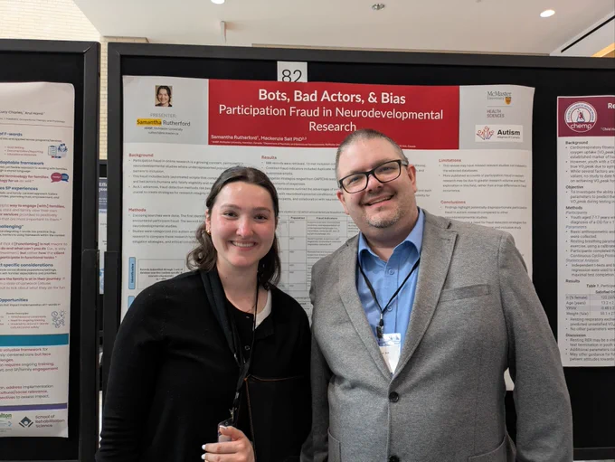 Dr. Mackenzie Salt and Samantha Rutherford smile and stand with their poster at McMaster Child Health Research Day.
