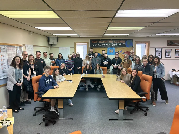 Group photo of students and educators at a meeting.