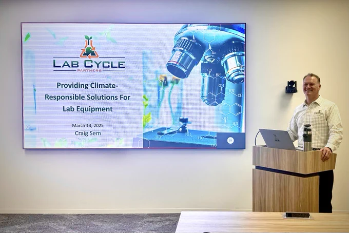 Craig Sem at the podium teaching about how Lab Cycle Partners' mission is to keep lab equipment out of landfills!