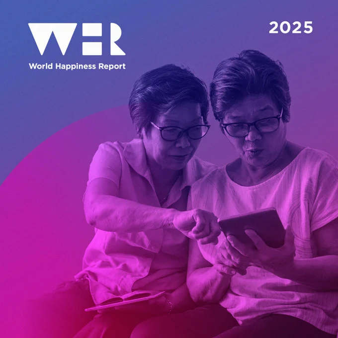 Two women using a computer tablet together.