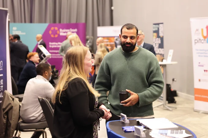 An exhibitor and attendee network informally at Venturefest West Midlands 2025