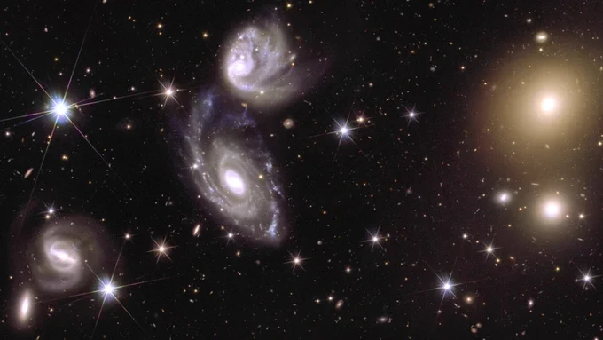 A 150x zoomed-in image from an Euclid mosaic. On the left are two interacting galaxies (ESO 364-G035 and G036), 420 million light-years away. On the right, galaxy cluster Abell 3381 is visible, 678 million light-years away. (Credit: ESA/Euclid/Euclid Consortium/NASA, CEA Paris-Saclay)