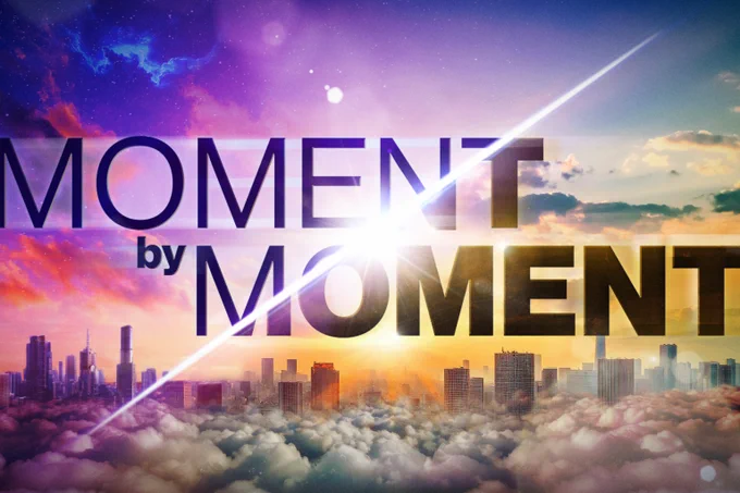 Moment by Moment artwork shows a cityscape in the clouds