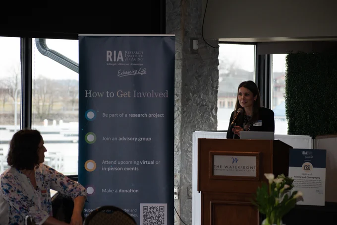 RIA team member speaking at podium 