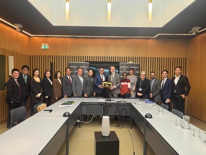 Group of people in a conference room looking towards the camera