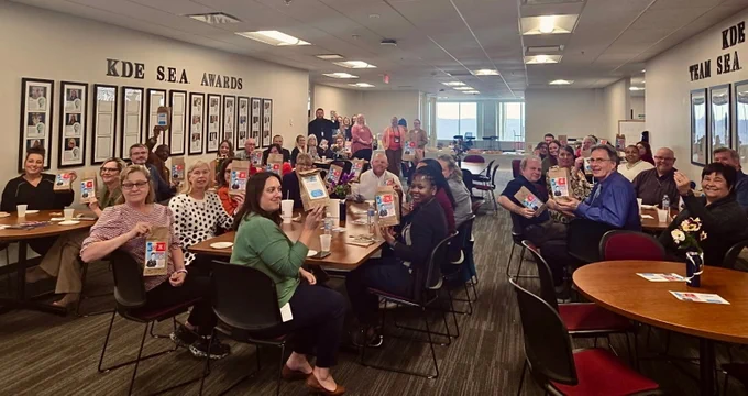 Kentucky Department of Education employees ate popcorn in honor of Eli Hill after the Team KDE meeting this week.