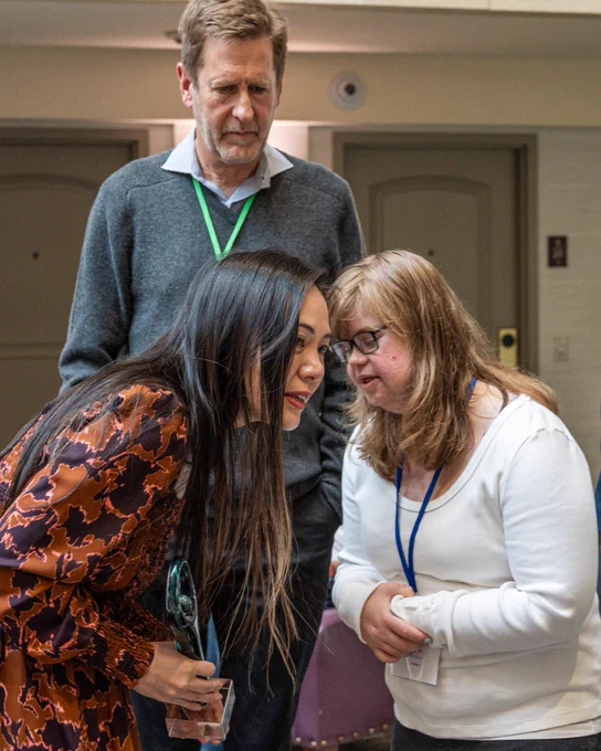Assemblymember Nguyen leans down to hear from Zoe, a Californian served by the regional center system