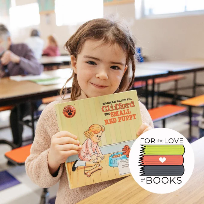 Student at Vernon Elementary in Portland holding a book they are reading with our SMART volunteer.