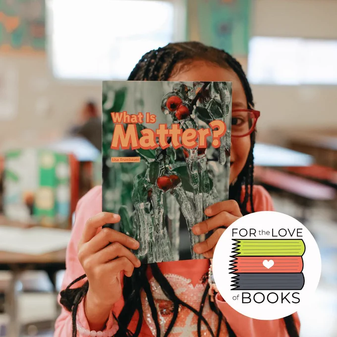 Student at Vernon Elementary in Portland holding a book they are reading with our SMART volunteer.
