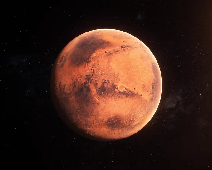 A close-up photograph of Mars taken on a pitch-black night.  