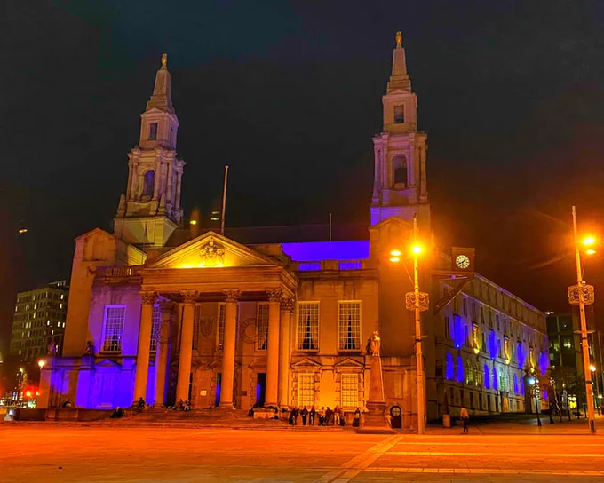 A council building in Leeds, lit up in blue and yellow