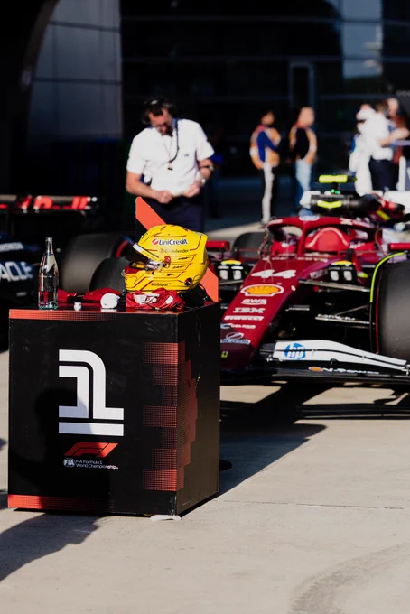 Lewis helmet and car next to the pole stand