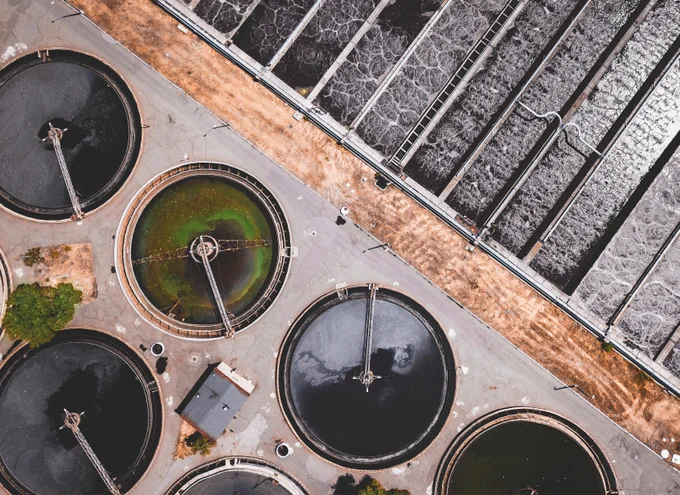 Water vats as seen from above. One contains green algae.