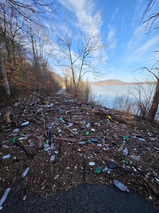 A mass of flood debris and trash blocks the road at Claylick Boat Ramp.