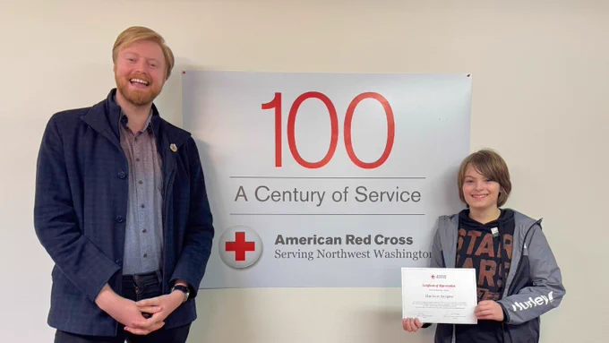 Alexander Newman of the Red Cross accepted the donation from Harrison and gave him a Certificate of Appreciation