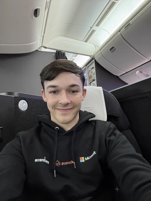 Lewis sat on a flight with an Accenture Avanade Microsoft hoodie on