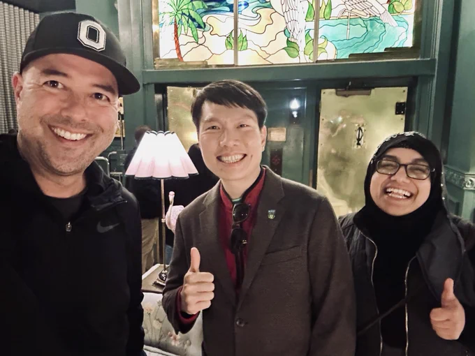 Selfie of Peter, Fun Man, and Safia, left to right by height. Fun Man and Safia with thumbs up.