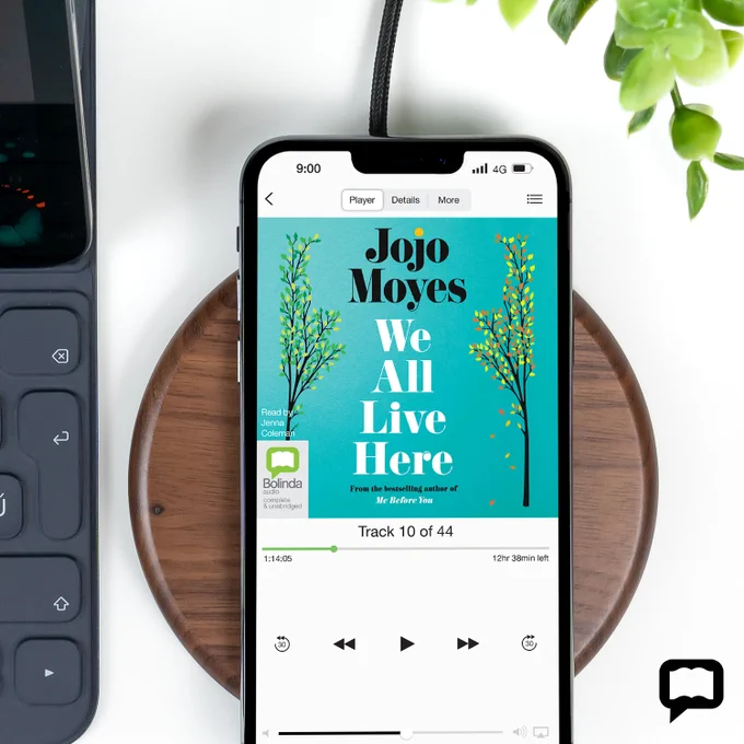 Mobile phone playing eaudiobook of We All Live Here by Jojo Moyes