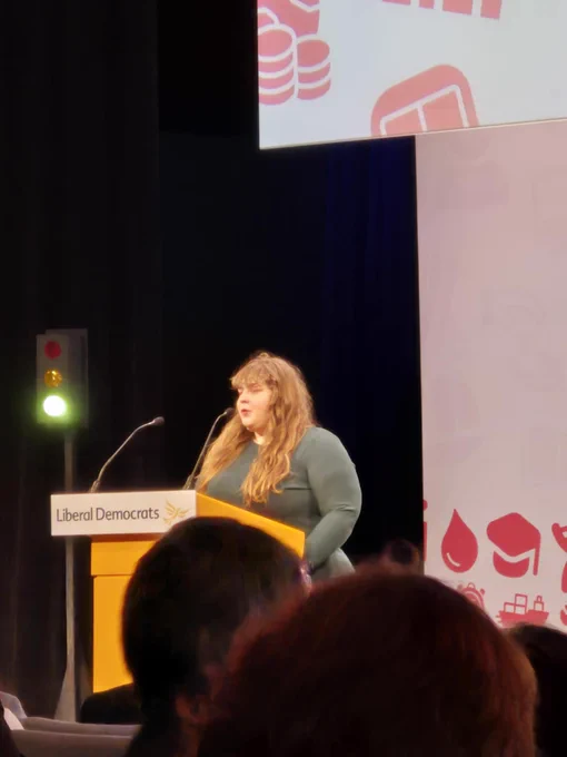 Katharine standing at the podium