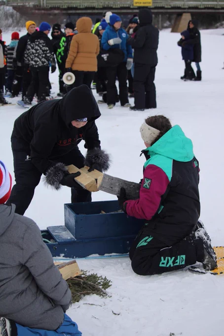 Students loading up a komatik with firewood.