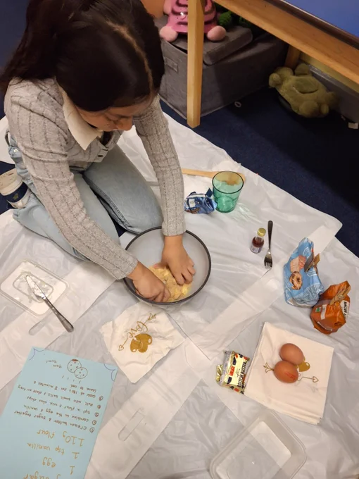 A picture of a young person making cookies.