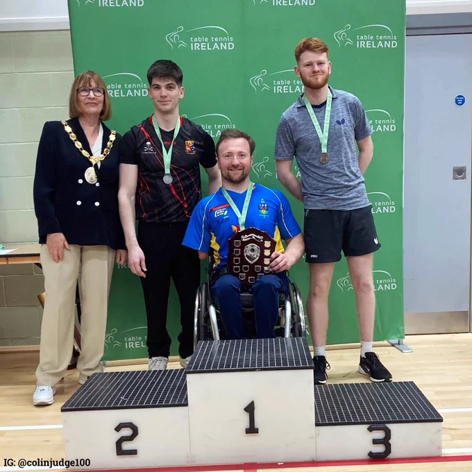 Colin Judge at the podium with four other people celebrating his victory