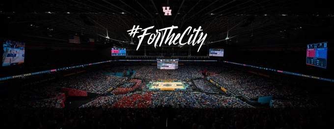 Wide shot of Alamodome interior during UH’s Final Four game against Duke. Hashtag For The City is above the court.