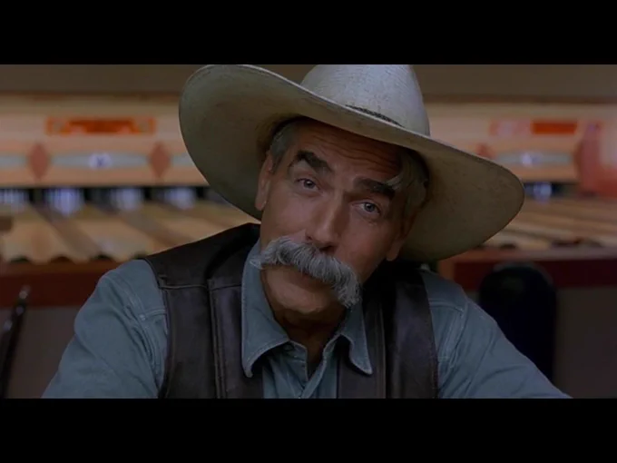 The Stranger looks directly at the viewer as he continues to deliver the movie’s closing monologue.
