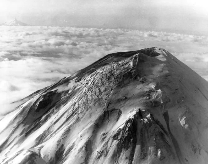 Aerial view of Mount St. Helens' upper flank, taken April 7, 1980. Mount Hood and Mount Jefferson are in the distance.