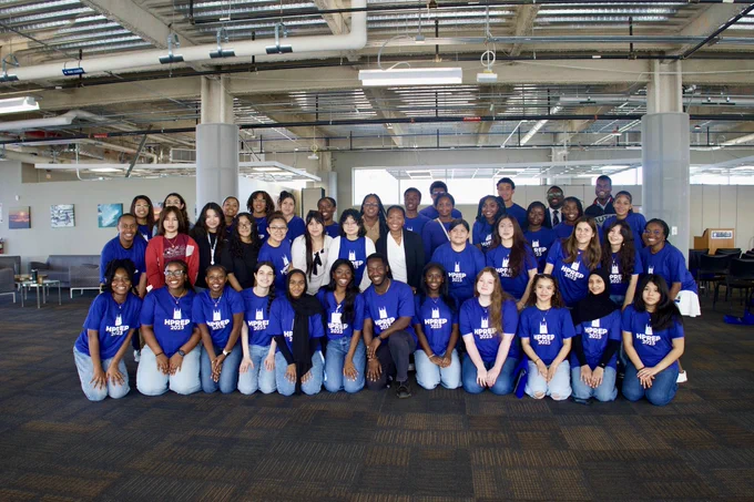 Group of people wearing blue shirts indoors