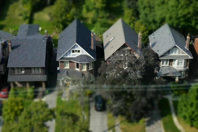 Aerial view of four detached houses in a residential Toronto neighbourhood.