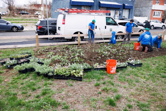 Volunteers planting flowers and plants at a City cleaning event