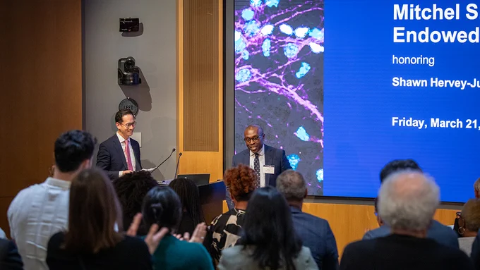 Shawn-Hervey Jumper, MD, receives a standing ovation as he takes the stage following remarks from neurosurgery department chair Edward Chang, MD.