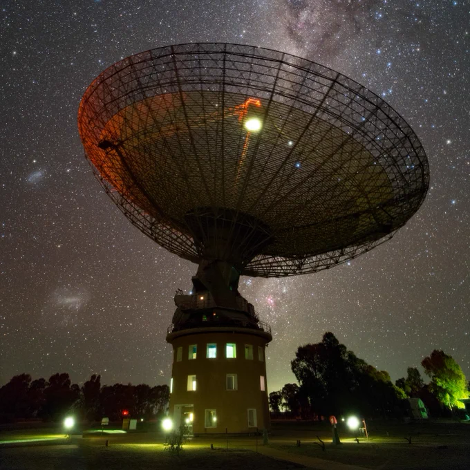 Big telescope dish points into a starry sky
