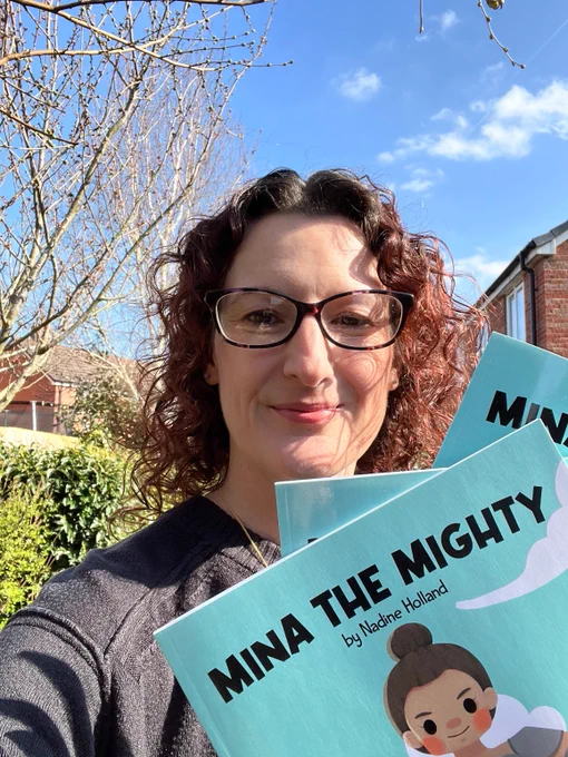 Author Nadine Holland with copies of Mina the Mighty