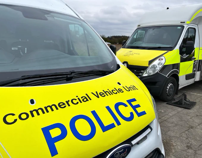 Police Commercial Vehicle Unit van and DVSA roadside van