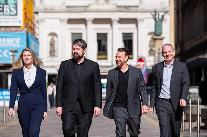 Image of Francesca Segarra, Grant Olin and Chris Ferriter of Halon with Adrian Gillespie Scottish Enterprise CEO, walking down a street in Glasgow city centre.