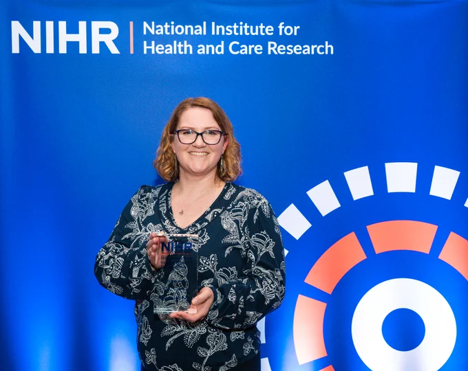 Dominique Balharry receiving an NIHR Impact Prize on behalf of the RESPIRE team