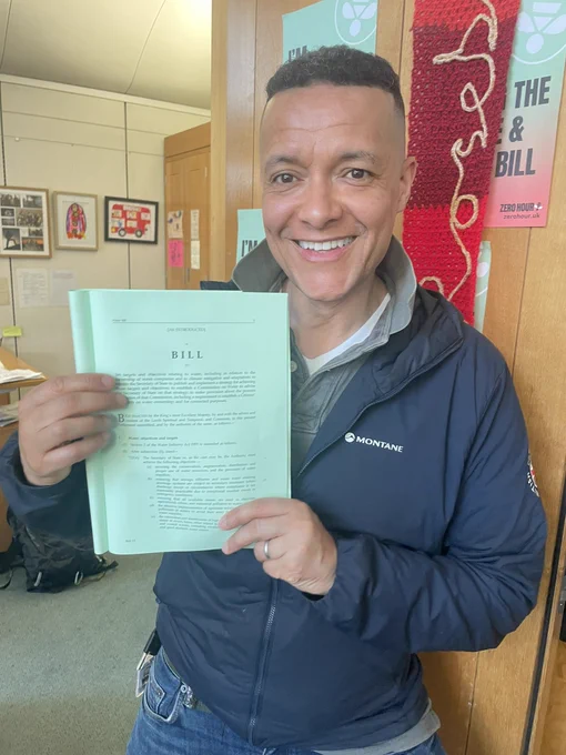 Clive Lewis MP holding up a printed copy of his Water Private Members’ Bill
