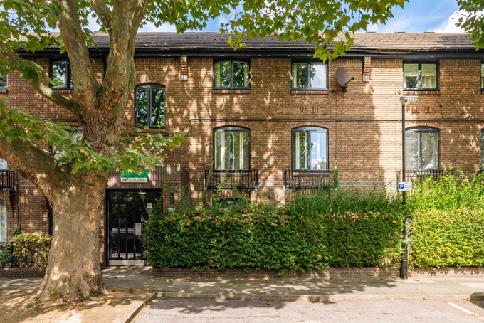 Red brick council housing with tree