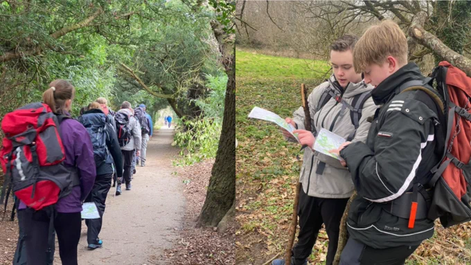 A group of young people hiking on a forest trail, with some examining a map closely.