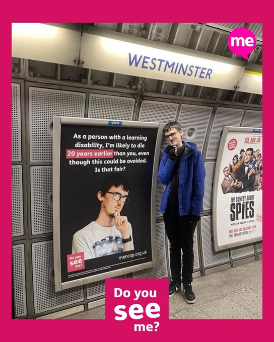 Mencap campaigners posing next to posters in the Westminster tube station.  The text says "People with a learning disability die, on average, up to 20 years younger than the general population, even though this could be avoided with the right healthcare."