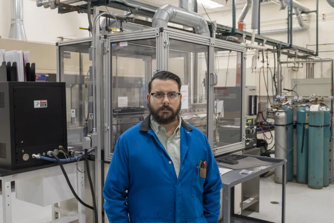 Trevor Aguirre stands in a materials lab.