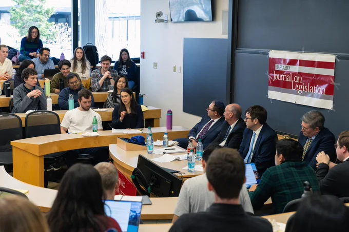Attendees looking on to the panel of professors. 