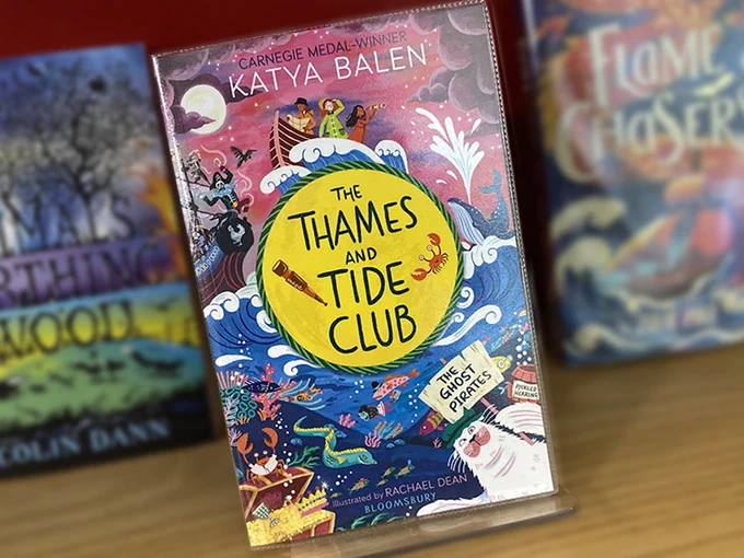 Book titled "The Thames and Tide Club - The Ghost Pirates" by Katya Balen displayed on a shelf among other books.