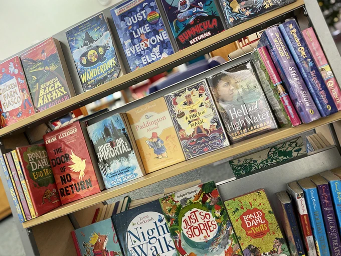 Popular books displayed on shelves with the heading ‘Just Returned’. 